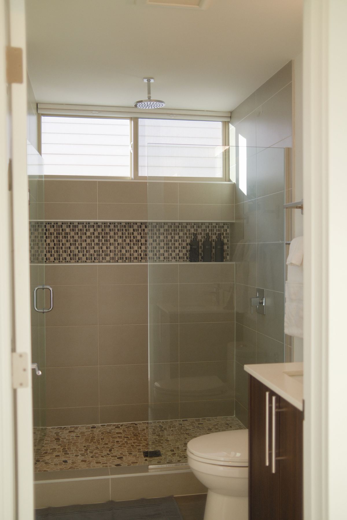 Walk-in glass shower with rain shower head