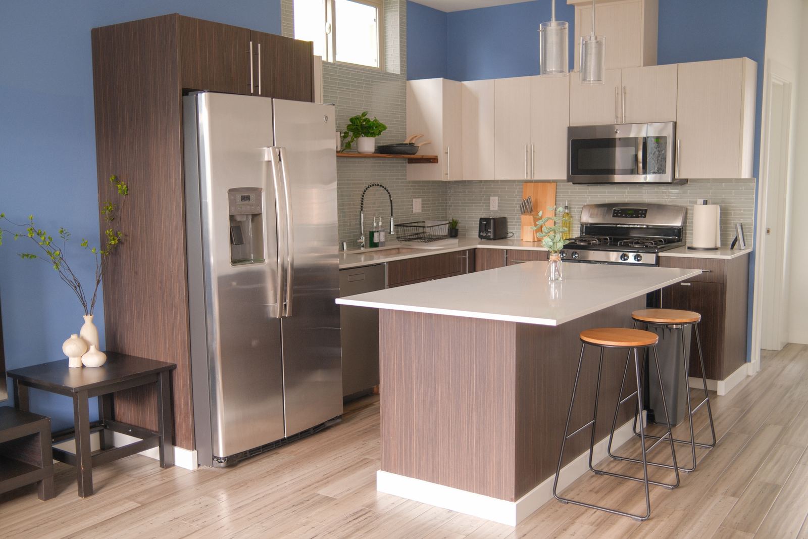Full kitchen with island seating, gas range, and stainless appliances